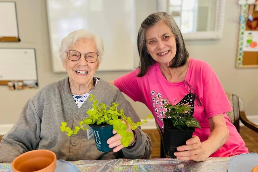 Cumberland Hills Assisted Living | Two residents at an assisted living facility potting plants