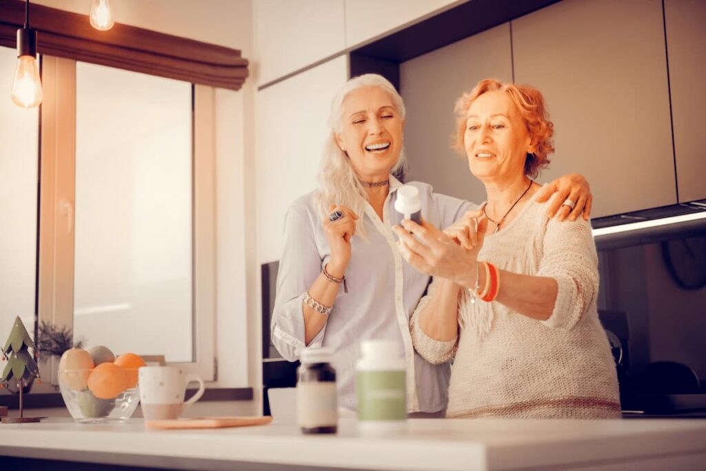 Williamsburg Landing | Senior Woman Recommending Vitamins To Her Friend