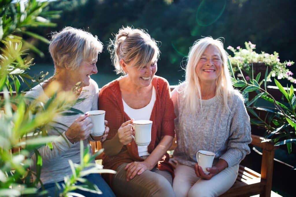 Williamsburg Landing | Senior Friends Sitting Outside Drinking Coffee