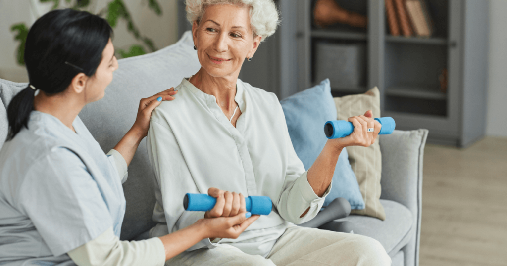 Nurse working with elder lady lifting weights to enhance living