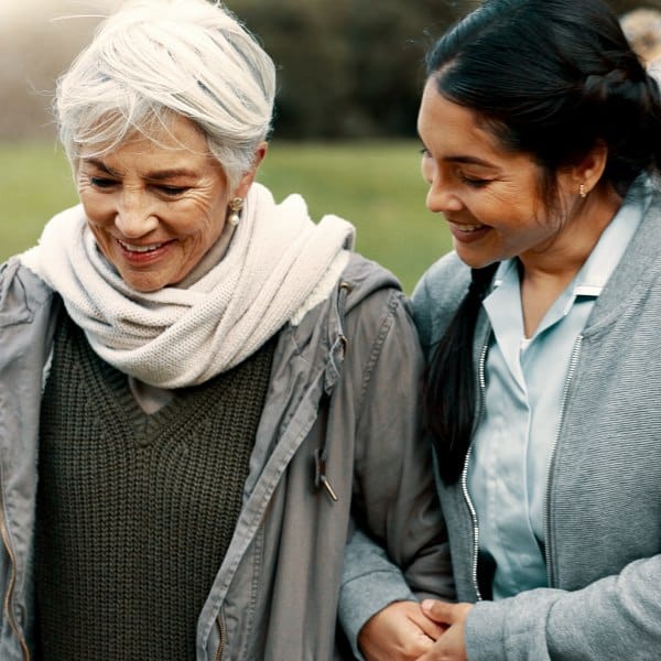 Golden Bell Senior Living | Senior woman walking with caregiver