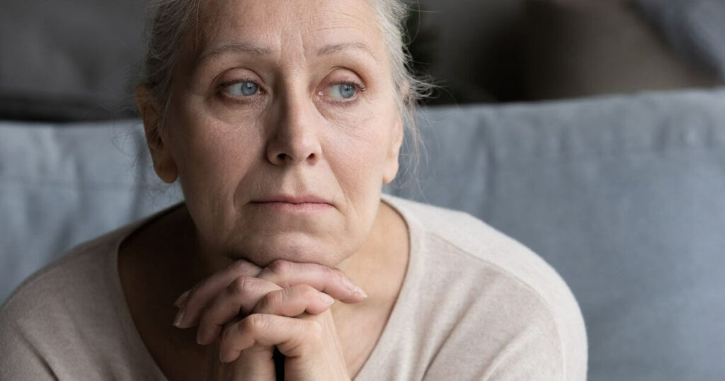 Adult woman looking full of guilt for moving in a loved one.