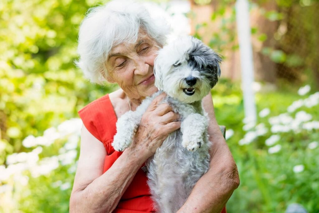 Cumberland Village | Senior woman with Her Dog In Her Garden